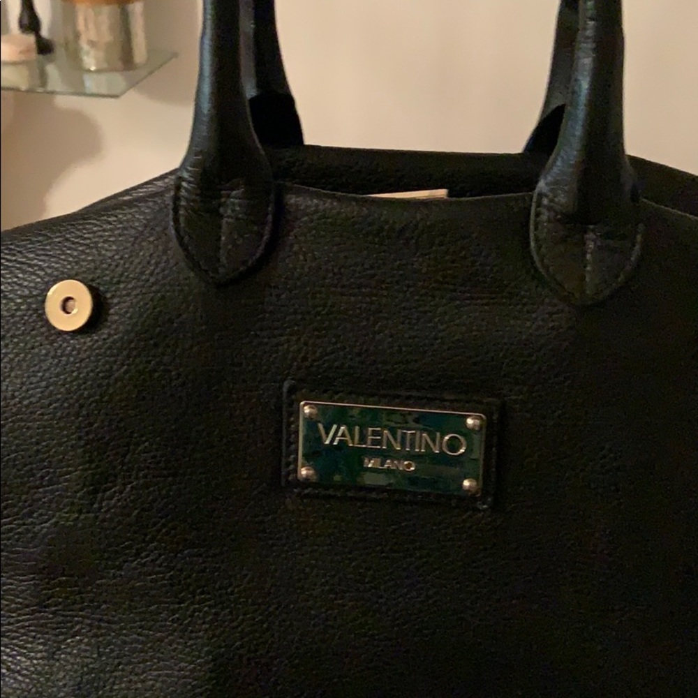 Valentino hangs bag!